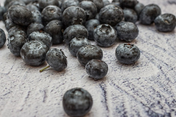 Blueberries with water drops on concrete background.