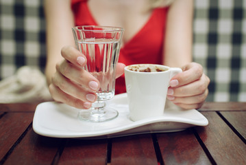 Close up view of woman with traditional turkish coffee.