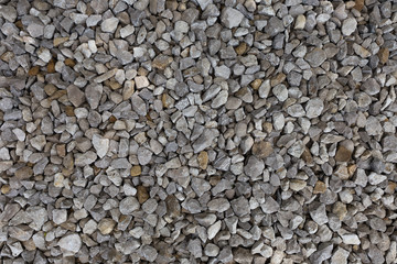 Construction breakstone background. Gravel road texture. The grey building rubble.