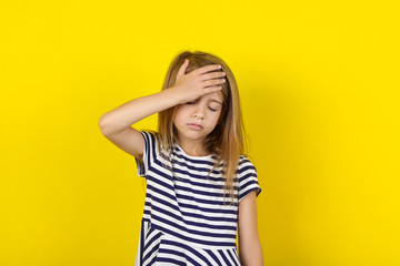 Beautiful little girl on yellow background