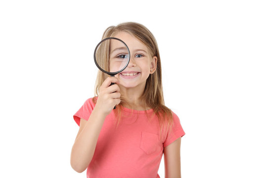 Little girl with magnifying glass isolated on white background
