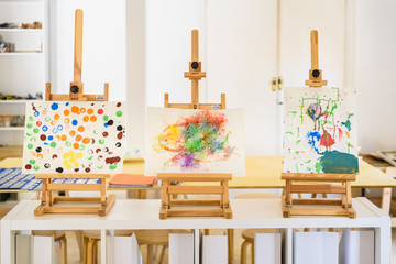 Valencia, Spain - April 4, 2019: Easels with watercolor paintings made by children in art class.