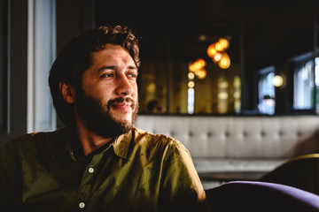 Young man with latin beard looking to infinity thinking about future business.