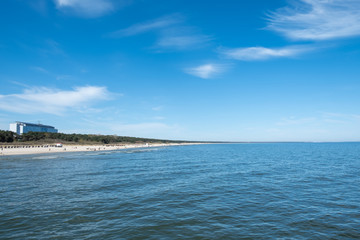 The beach of Zinnowitz on a sunny day. You see the Hotel Baltic.