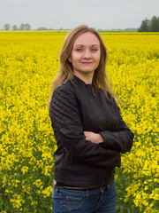 Portrait of young woman on yelllow cole field background