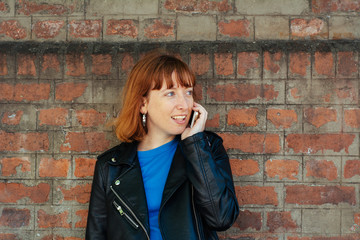 Redhead woman woman talking on her mobile phone.