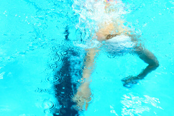 Obraz na płótnie Canvas Portrait of a swimmer on the background of the pool.