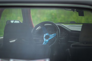 sports car from the inside blue seats orange safety cage night shooting in the dark