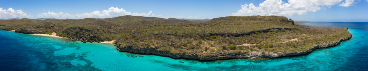 Fototapeta na wymiar Aerial view of coast of Curaçao in the Caribbean Sea with turquoise water, white sandy beach and beautiful coral reef at Playa Manzalina 