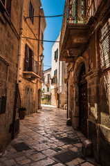Fototapeta na wymiar Narrow cute street in Italy on sunny weather