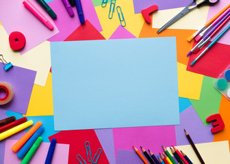 School supplies lay on colorful background, back to school concept, copy space, vertical