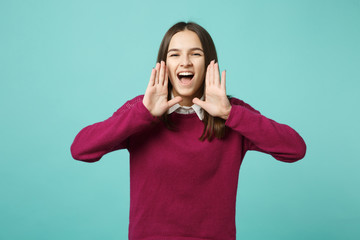 Young brunette woman girl casual clothes posing isolated on blue green turquoise wall background studio portrait. People sincere emotions lifestyle concept. Copy space. scream with hand near mouth