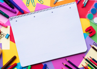 Notebook with school supplies on color background with copy space