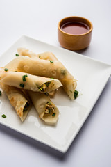 Paneer chilli cigar are crispy rolls stuffed with paneer which is an interesting starter for any party. served with tomato ketchup. selective focus