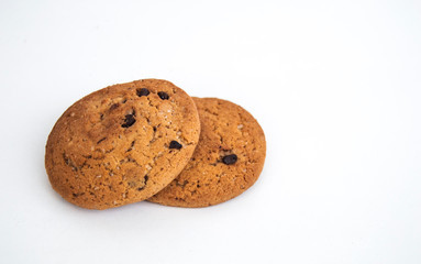 Two cookies with chocolate crumbs on a white background. Horizontal photo