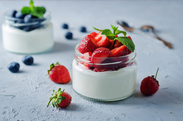 Greek yogurt strawberry and blueberry parfaits with fresh berries - obrazy, fototapety, plakaty