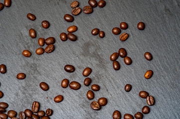 Arabica coffee beans on a stone background. Close up. Top view.