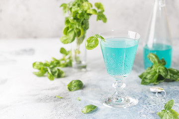 Colorful refreshing summer drink with basil seeds on light background.