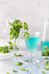 Colorful refreshing summer drink with basil seeds on light background.