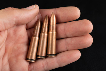 Ammunition of a quick-fire rifle held in the palm of your hand. Cartridges for a military rifle.