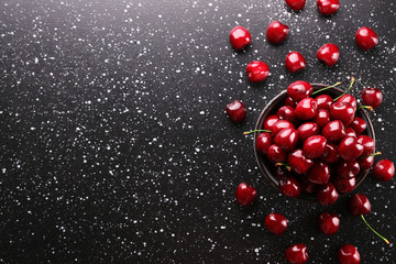 Bunch of fresh organic sweet cherries on textured background. Clean eating concept. Healthy nutritious vegan snack, raw diet. Close up, copy space, top view, flat lay.