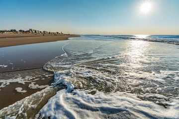 Sunny day on North sea beach in Netherlands in Scheveningen, tourist and vacation destination in...