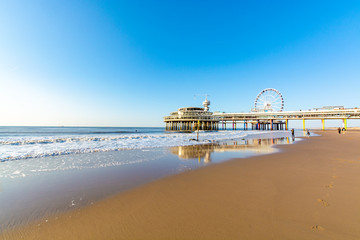Sunny day on North sea beach in Netherlands in Scheveningen, tourist and vacation destination in...