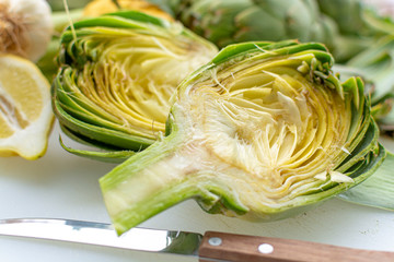 Preparation of heads of fresh raw artichokes plants from artichoke plantation in Argolida, Greece...