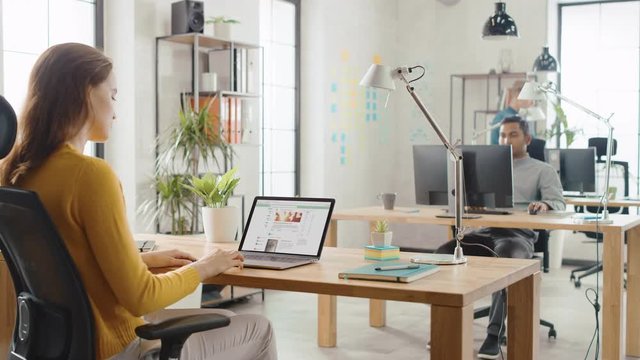 Over the Shoulder: Female Employee Browses Through Social Media Network Site, Browsing the Wall