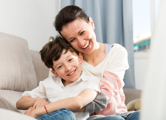 Obraz premium Cheerful teen boy with mother
