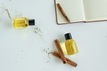Top view of bottles with cinnamon essential oil. Healthy cosmetic product