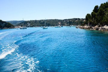 A relaxing view with clear and turquoise water in a wonderful bay and beach of the Greek island.