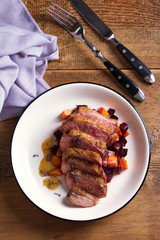 Duck breast with lavender, beetroot, sweet potato and maple syrup. View from above, top studio shot