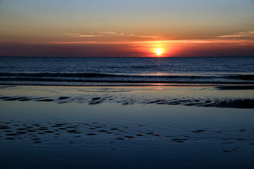 Sandy beach on the Baltic Sea on the Curonian Spit in Lithuania in the evening during sunset.