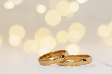Wedding background with two golden rings.