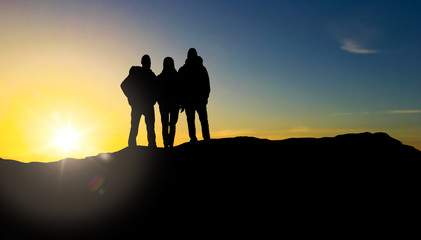 travel, tourism and hike concept - group of travellers with backpacks on mountain top over sunrise background