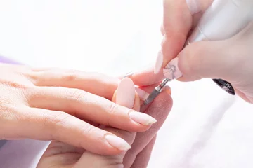 Stickers muraux ManIcure Treatment of the nail on the hand with a special apparatus with a cutter for manicure