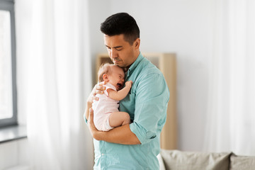 family, parenthood and fatherhood concept - middle aged father comforting little baby daughter at...