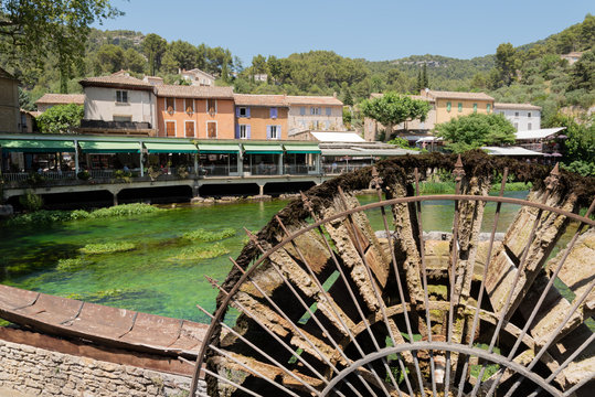 Famous place of Provence France, Fontaine de Vaucluse village on Sorgue river, water wheel with and clean green water
