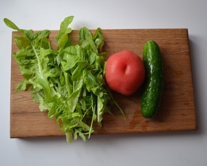 fresh vegetables on a wooden board. Tomato, cucumber, salad.