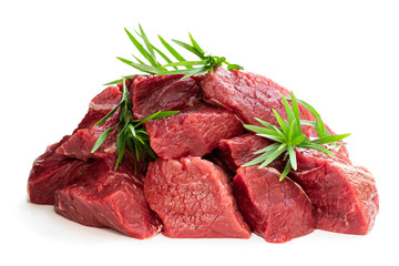 Sliced raw beef with tarragon herb isolated on white