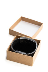 Homemade open gift box made from brown paper with bracelet isolated on white