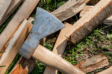 The used ax is lying on the wood for fire