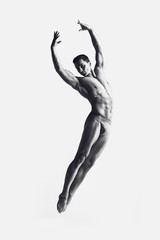 Dance freedom concept. Young handsome ballet man in fly grace pose. Perfect hair & skin. Close up....