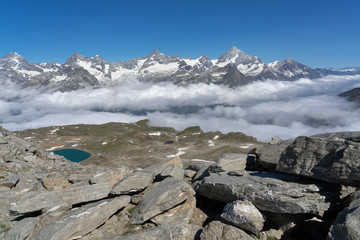 Fototapeta na wymiar morning clouds over the Valley of Zermatt, view from Gornergrat to the north with Weisshorn, Zianlrothorn and Obergabelhorn