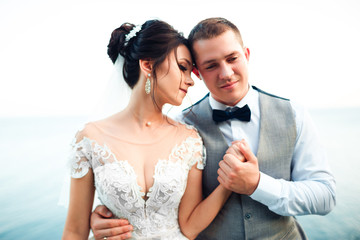The guy and the girl are smiling at each other. Classic young wedding couple.