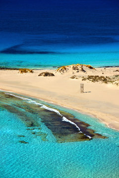 The famous "double" beach known as "Simos" (in fact, the one in front is called "Frangos" and the other in the back "Sarakiniko") in Elafonisos island, Lakonia, Peloponnese, Greece.
