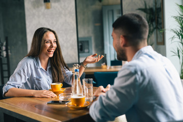 A happy young couple on a date at a fancy restaurant