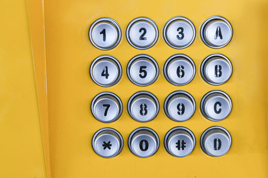 Yellow numeric number of public phone.