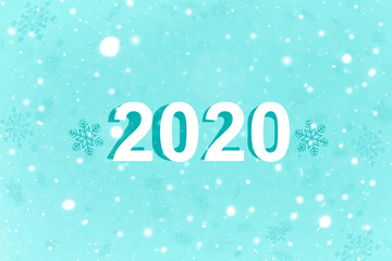 The inscription 2020 on a blue background with snowflakes. New year 2020. New year background, copy space.